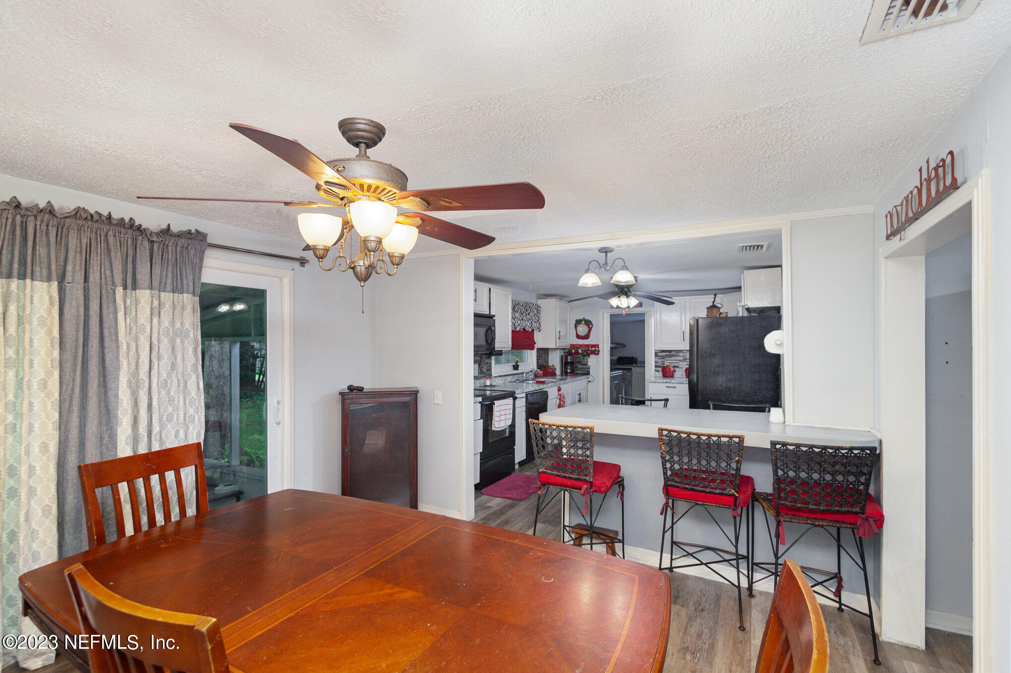 145 North Orange Street Starke, FL 32091 - Photo 9 of 26 a living room with furniture a chandelier and a flat screen tv