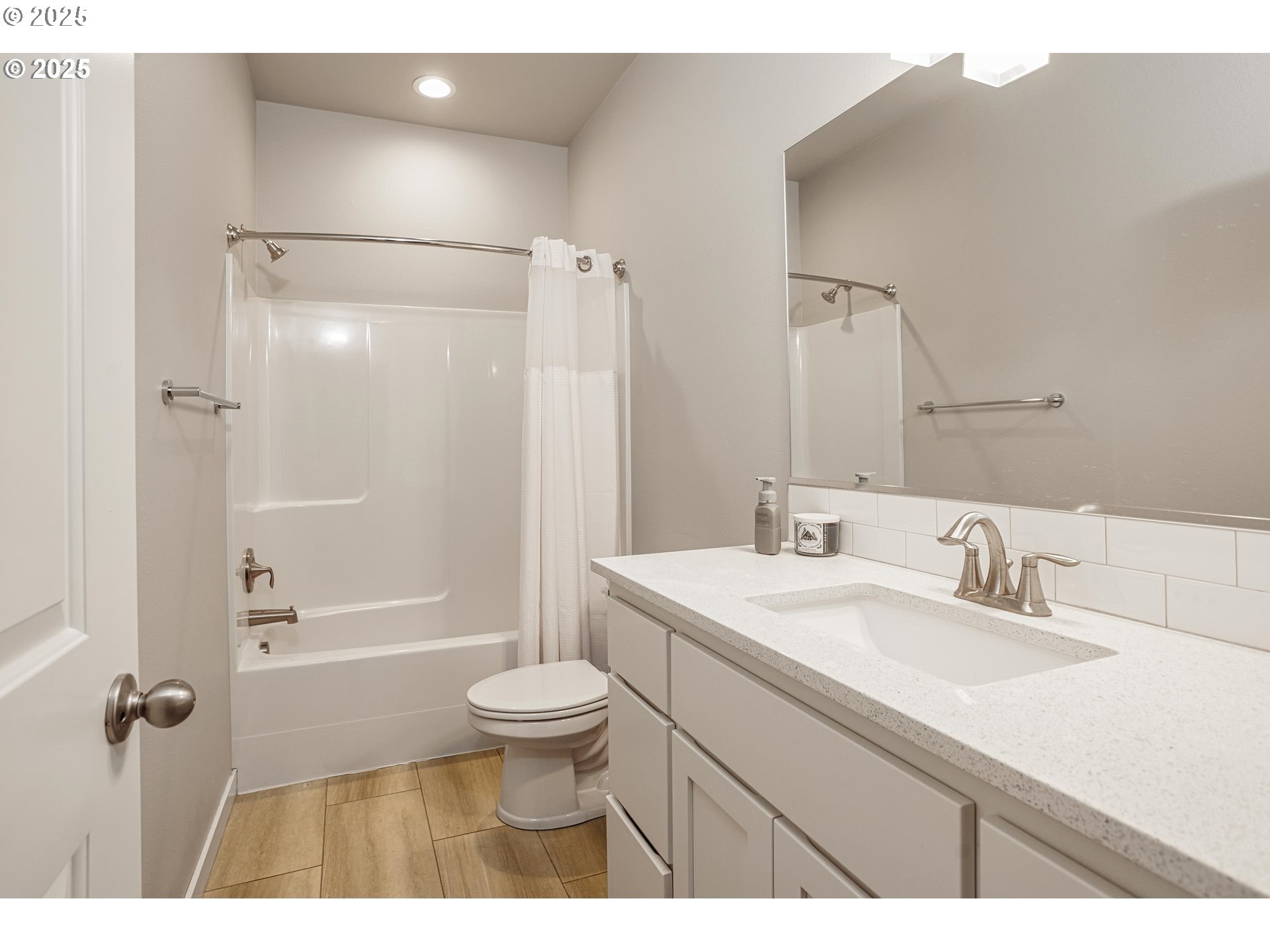 2030 North 4th Way Ridgefield, WA 98642 - Photo 19 of 26 a bathroom with a sink a toilet a mirror and shower