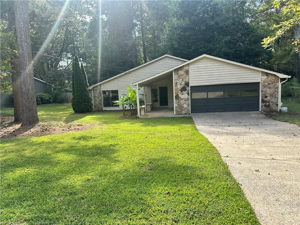 a view of a house with a yard and garage