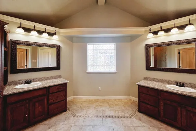 a bathroom with a sink vanity and mirror