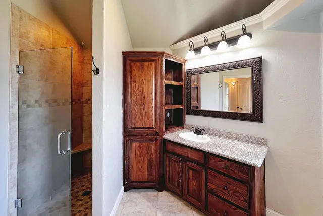 a bathroom with a sink vanity and a mirror