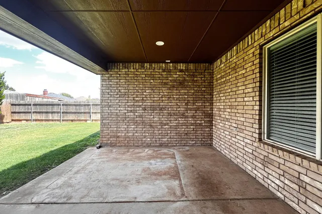 a view of a house with a yard and a tree