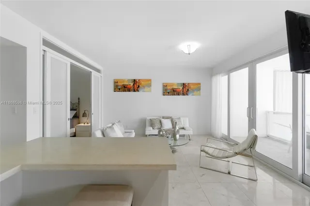 a bedroom with a bed and large window