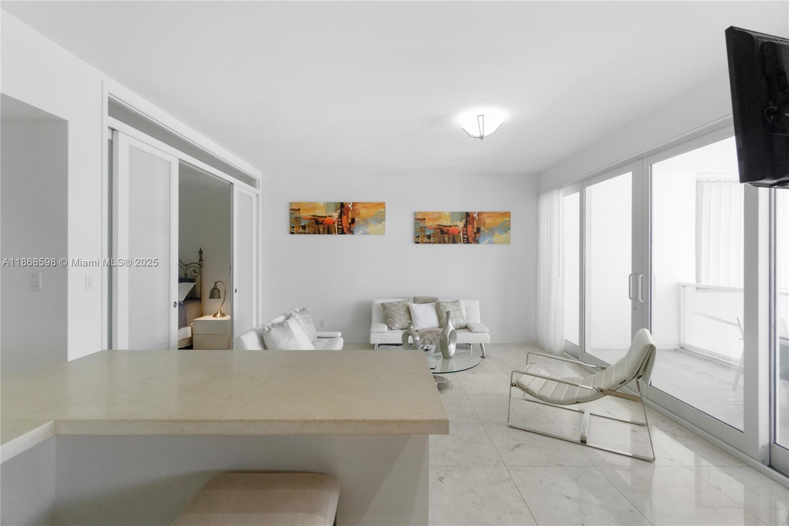 100 Lincoln Road, Unit PH14 Miami Beach, FL 33139 - Photo 12 of 33 a living room with furniture and large windows