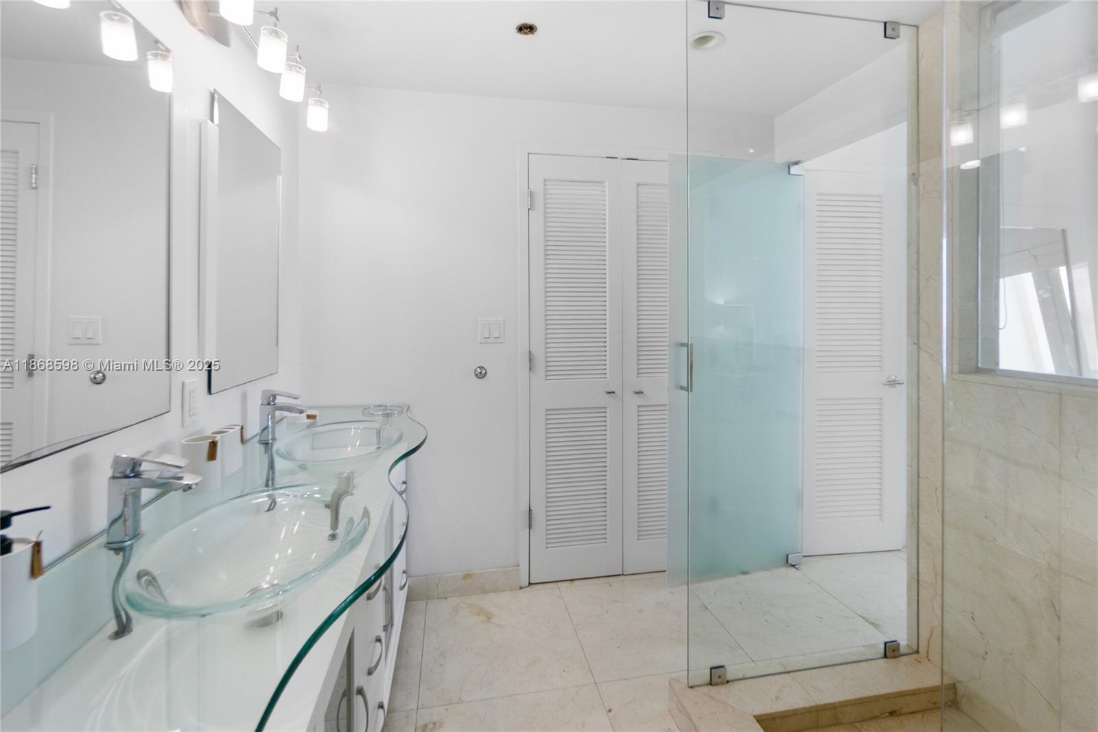 100 Lincoln Road, Unit PH14 Miami Beach, FL 33139 - Photo 19 of 33 a bathroom with a sink a toilet and shower