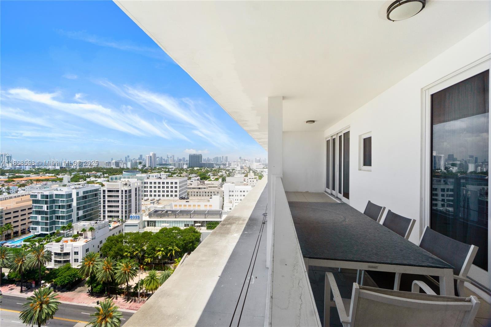 100 Lincoln Road, Unit PH14 Miami Beach, FL 33139 - Photo 2 of 33 a view of a balcony with table and chairs
