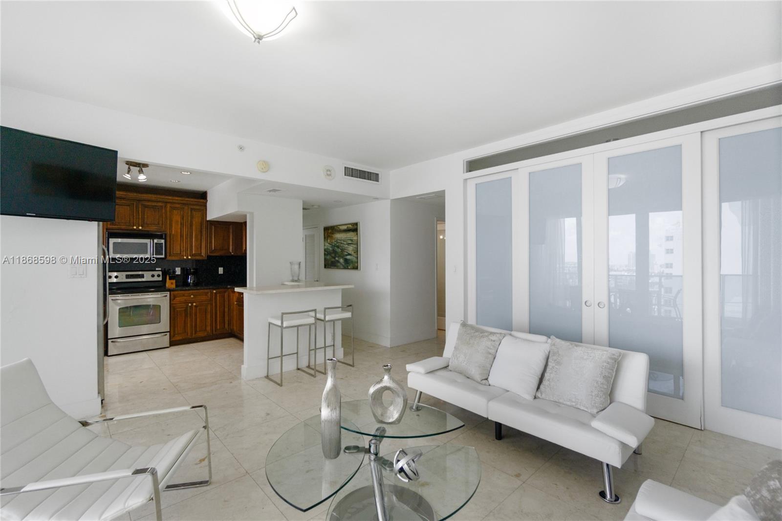 100 Lincoln Road, Unit PH14 Miami Beach, FL 33139 - Photo 9 of 33 a living room with furniture and kitchen view