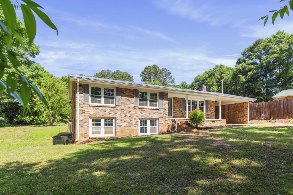 104 Doyle Drive Seneca, SC 29678 - Photo 17 of 19 This classic brick residence features a spacious yard and inviting carport, blending comfort with outdoor appeal.