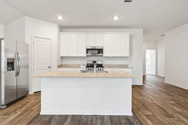 a bathroom with a sink a mirror a vanity and a shower