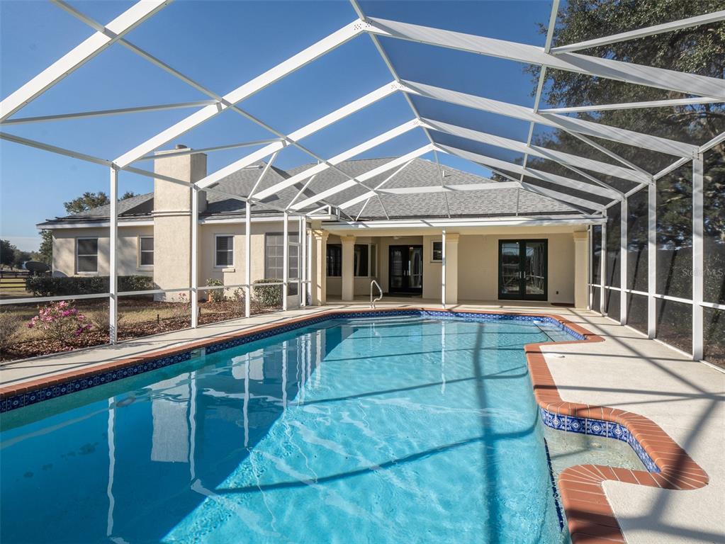 2185 Northwest 114th Loop Ocala, FL 34475 - Photo 16 of 25 a view of a house with a swimming pool