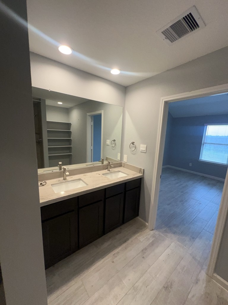 5327 Cherry Tallow Trail Katy, TX 77449 - Photo 12 of 18 a bathroom with a double vanity sink and a mirror