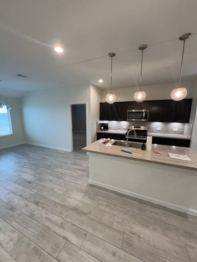 5327 Cherry Tallow Trail Katy, TX 77449 - Photo 3 of 18 a open kitchen with kitchen countertops and stove