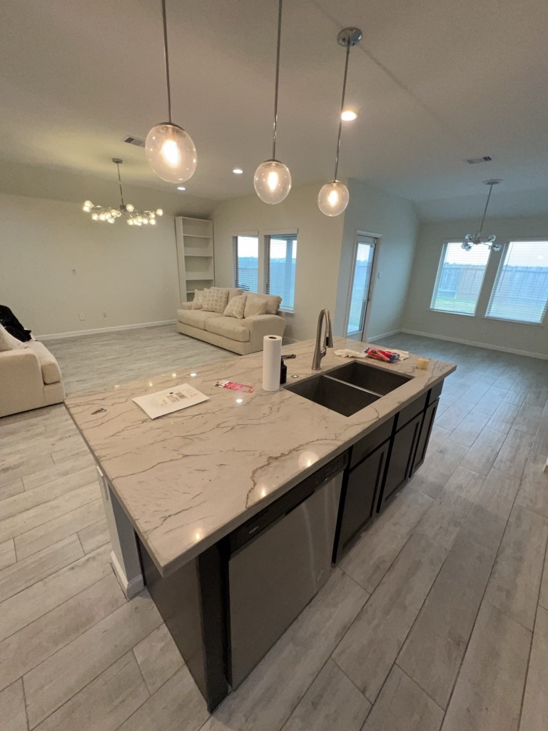 5327 Cherry Tallow Trail Katy, TX 77449 - Photo 4 of 18 a kitchen with stainless steel appliances granite countertop wooden cabinets a sink a counter space and a refrigerator