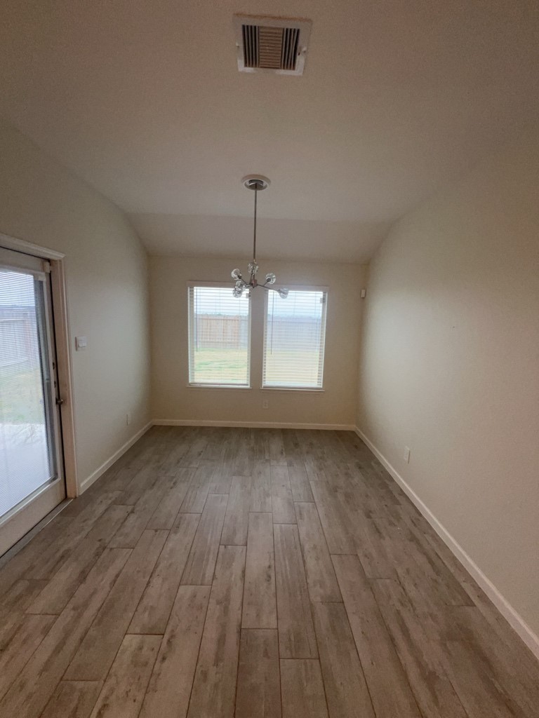 5327 Cherry Tallow Trail Katy, TX 77449 - Photo 6 of 18 an empty room with wooden floor and windows