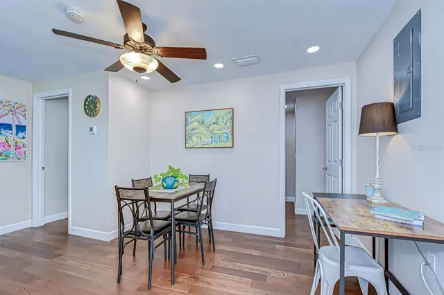a view of a dining room with furniture and wooden floor