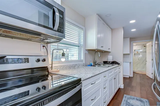 a kitchen with stainless steel appliances granite countertop a stove and a sink