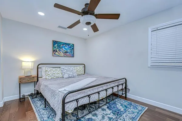 a bedroom with a bed and a lamp on a table