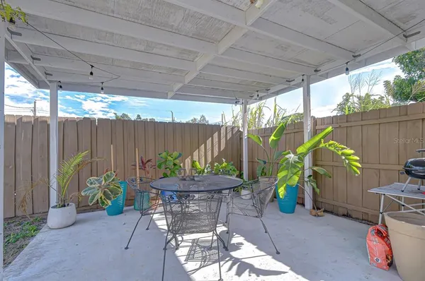 a backyard with furniture and a potted plant