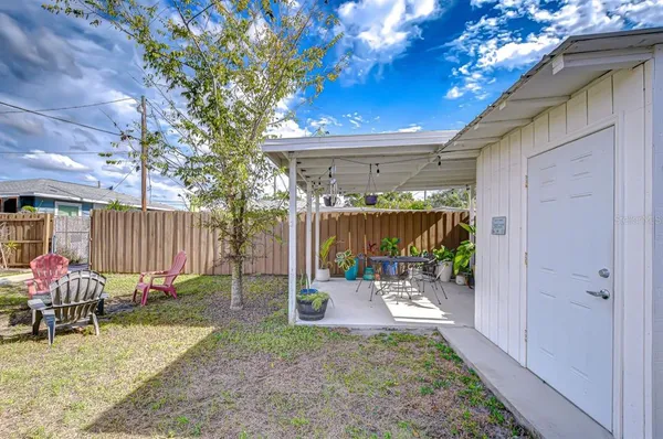 a backyard of a house with yard and outdoor seating