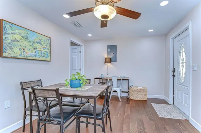 a view of a dining room with furniture and wooden floor