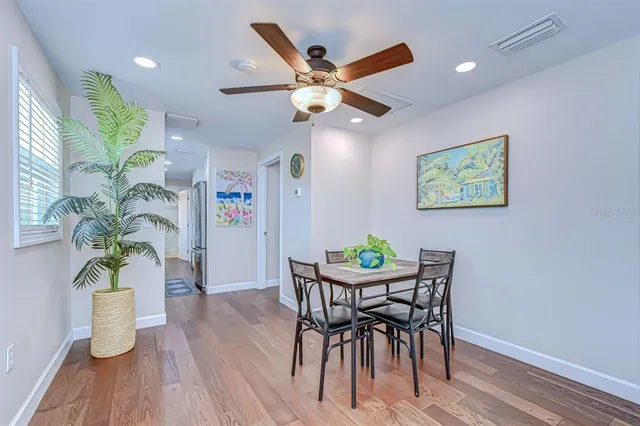 a view of a dining room with furniture and a potted plant
