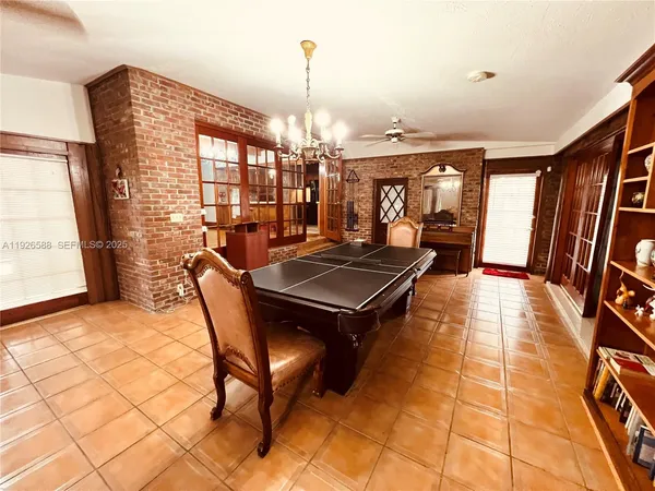a dining room with furniture and a chandelier