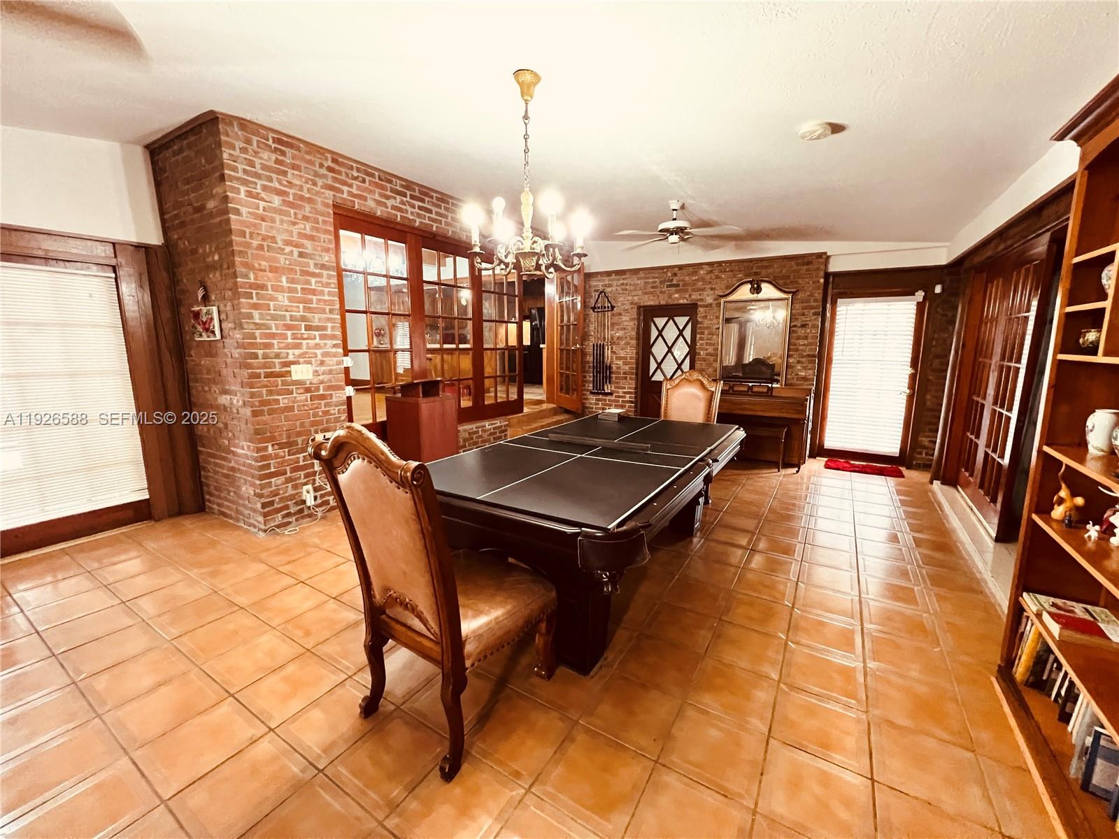 29625 Southwest 153rd Court Homestead, FL 33033 - Photo 11 of 17 a dining room with furniture and a chandelier