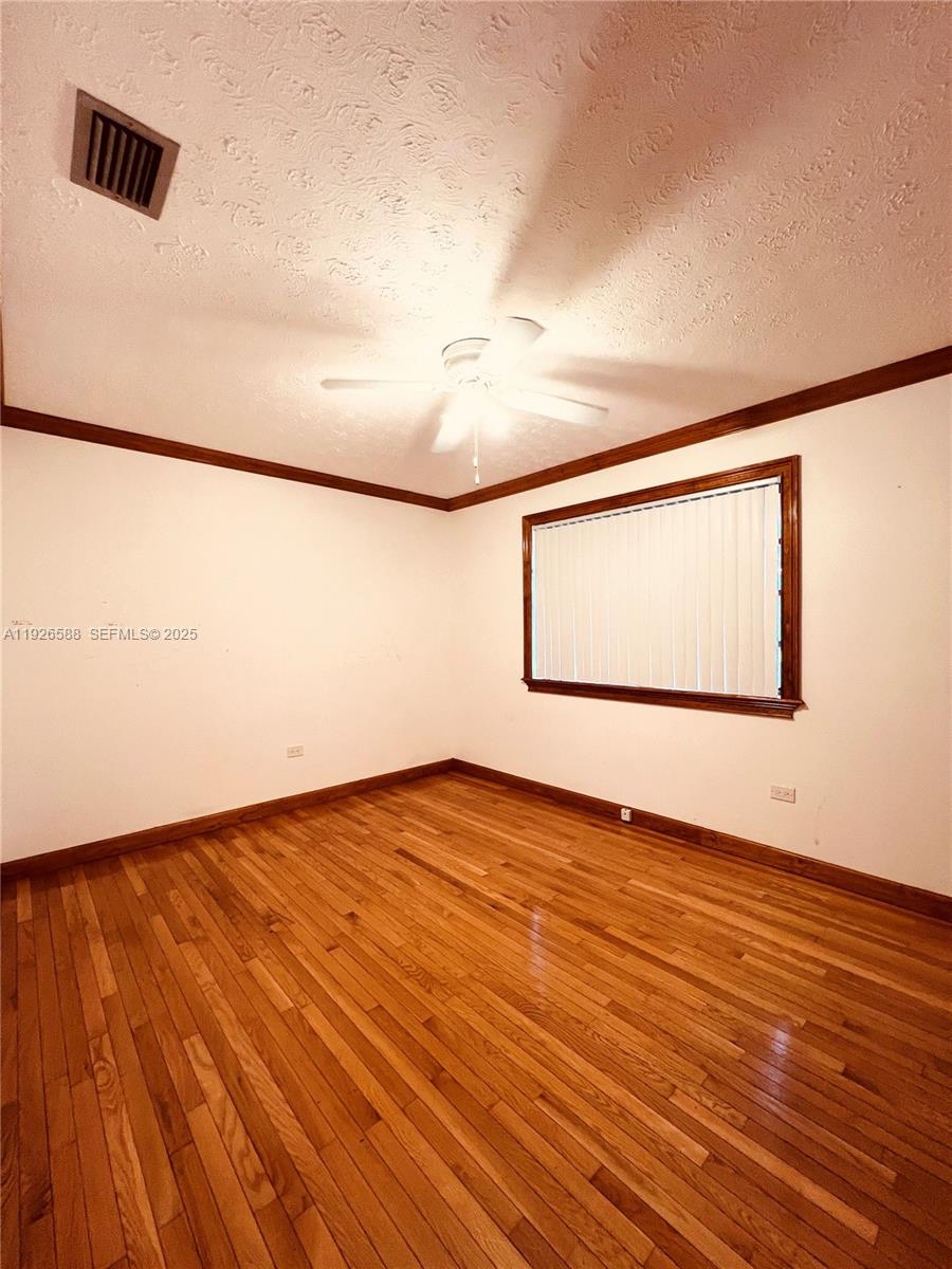 29625 Southwest 153rd Court Homestead, FL 33033 - Photo 5 of 17 a view of an empty room and wooden floor