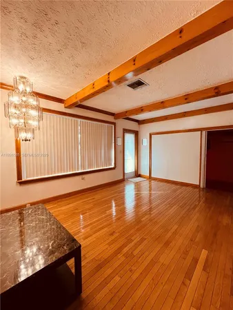 a view of a room with wooden floor