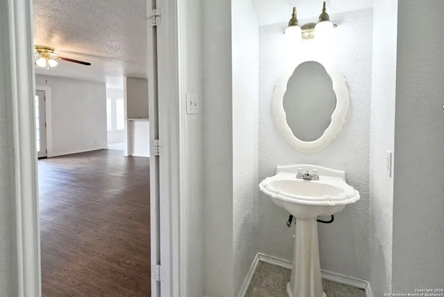a bathroom with a sink and a mirror