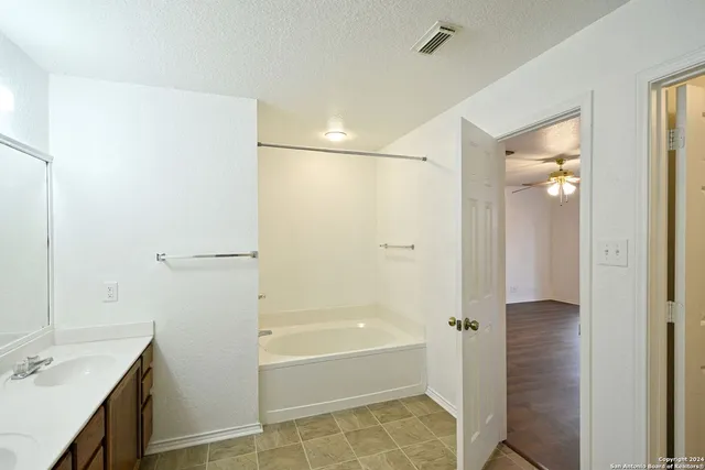 a bathroom with a shower and a sink