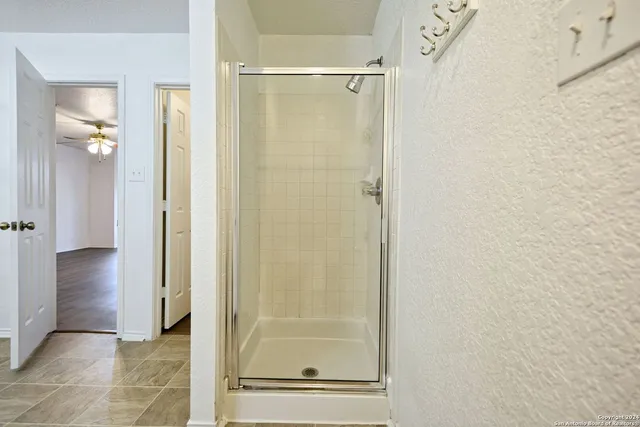 a bathroom with a glass shower door