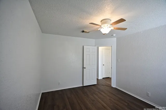 a view of an empty room with a fan