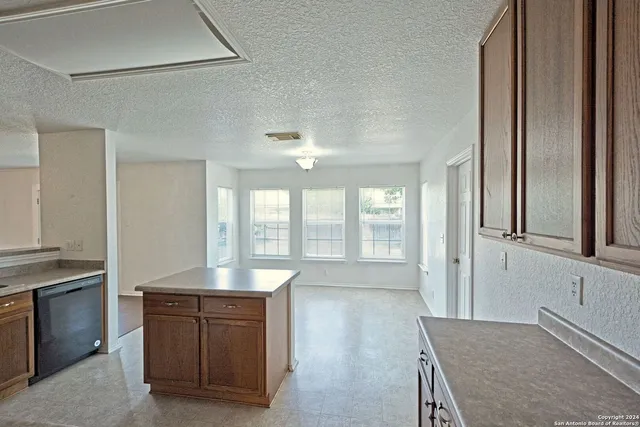 a spacious bathroom with a granite countertop sink and a large mirror