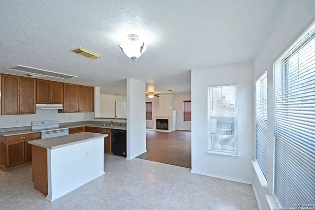a kitchen with cabinets and window