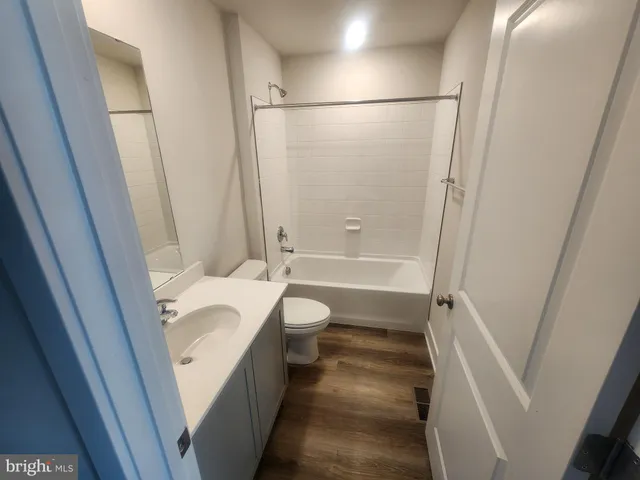 a bathroom with a granite countertop shower and a sink