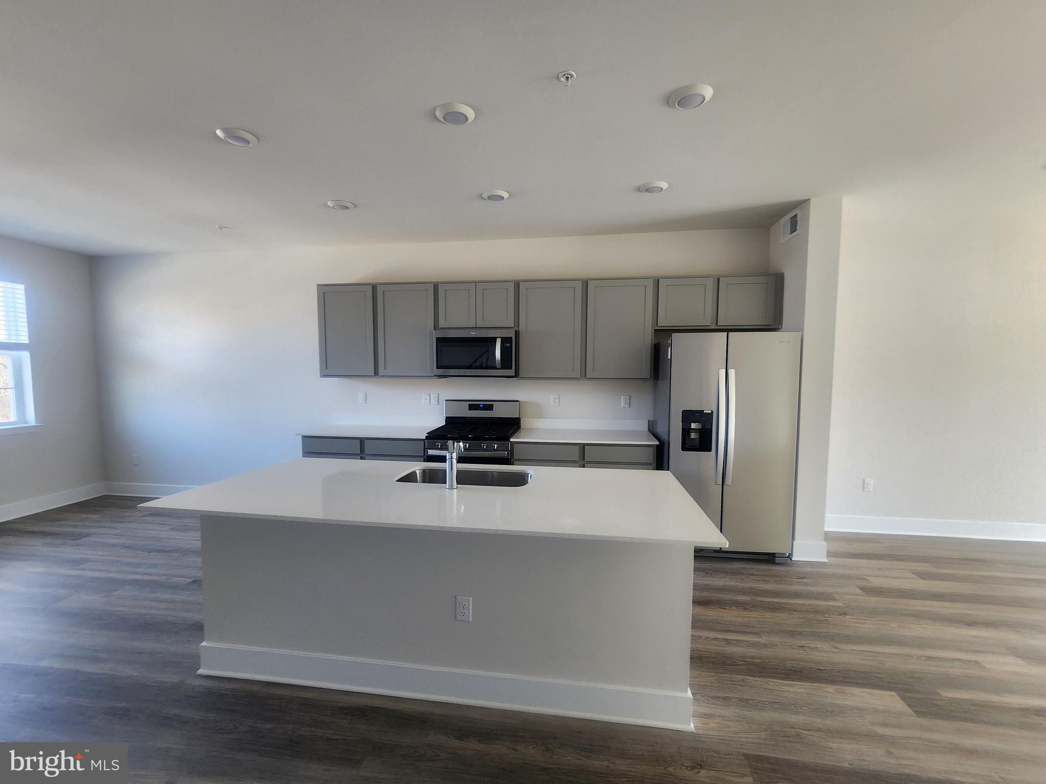 231 Joppa Farm Road Joppa, MD 21085 - Photo 20 of 25 a kitchen with stainless steel appliances a sink a stove a refrigerator and cabinets