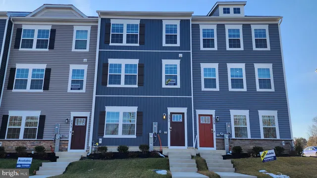 front view of a brick house with a yard