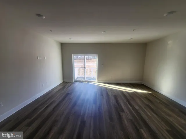 a view of an empty room and a window