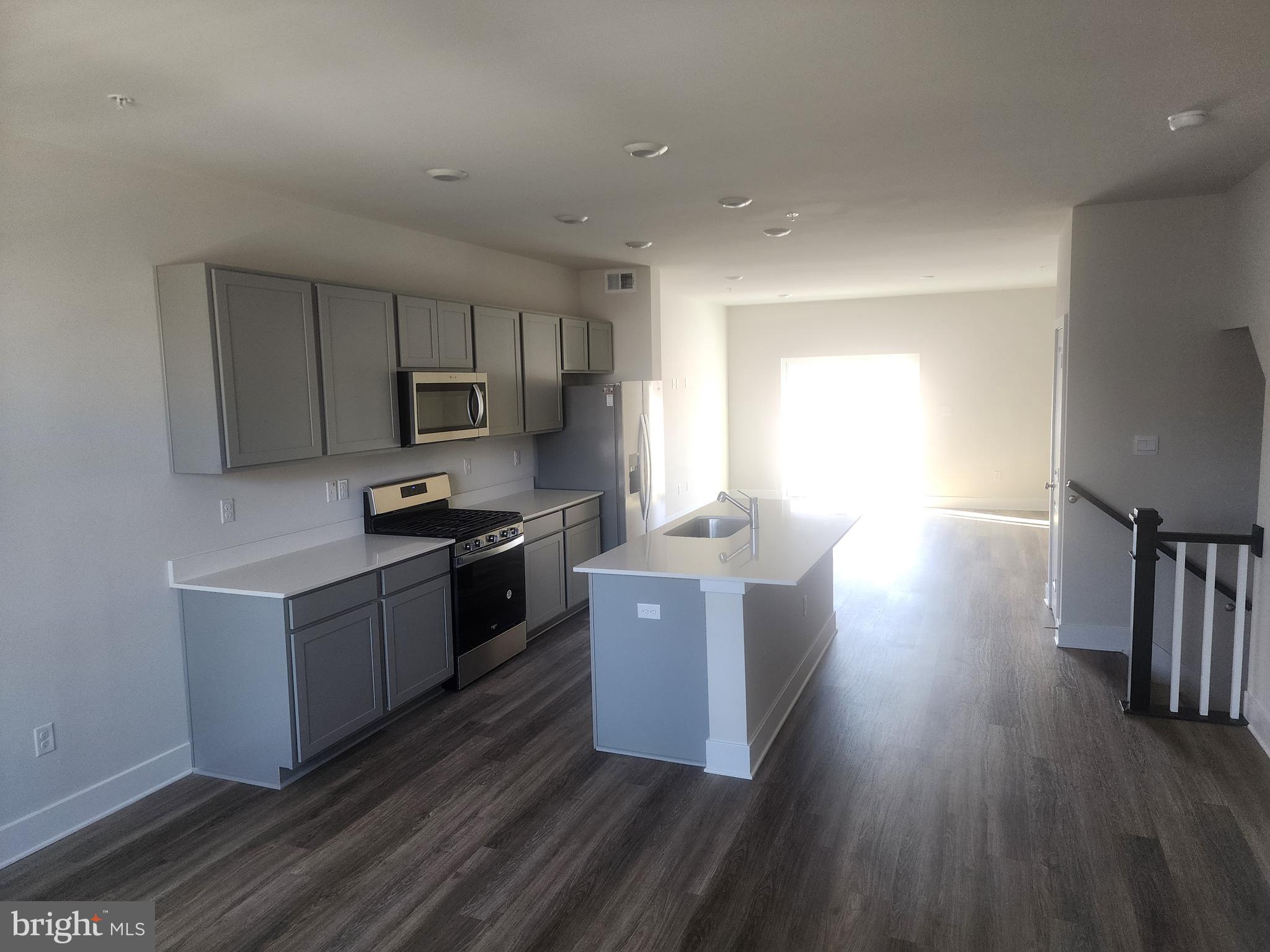 231 Joppa Farm Road Joppa, MD 21085 - Photo 10 of 25 a kitchen with stainless steel appliances granite countertop wooden cabinets a stove top oven a sink and dishwasher