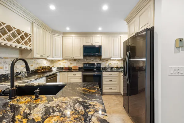 a kitchen with a refrigerator stove and oven