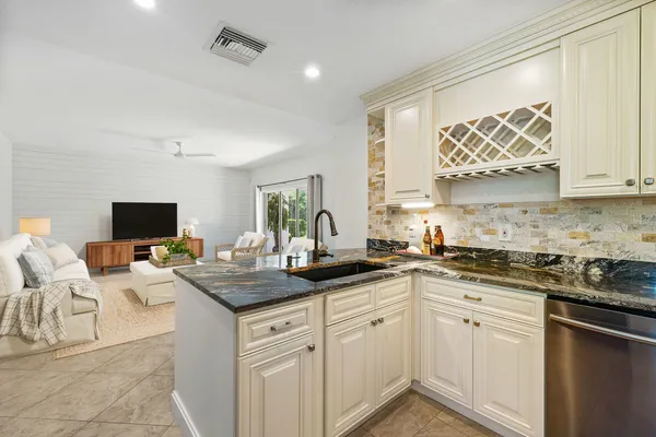 a kitchen with a sink stove and cabinets