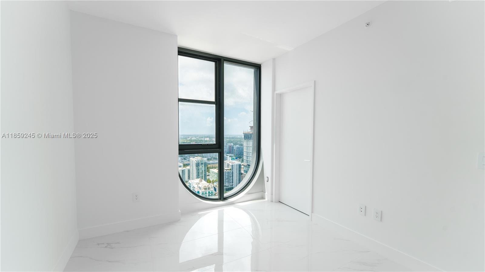 700 Northeast 24th Street, Unit 3401 Miami, FL 33137 - Photo 42 of 68 a view of a livingroom with wooden floor and a window