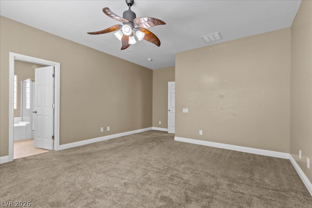 2627 Dirleton Place Henderson, NV 89044 - Photo 20 of 42 Ceiling fan, abundant natural light, and a spacious layout create the perfect place to unwind.