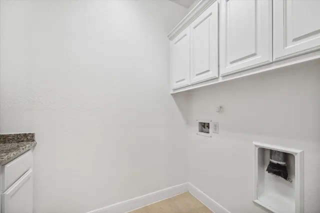 a view of storage and utility room with cabinets