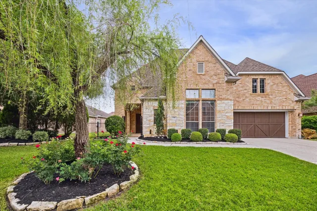 a front view of a house with a garden and plants