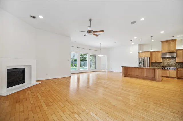 a view of an empty room with a kitchen and a kitchen counter top