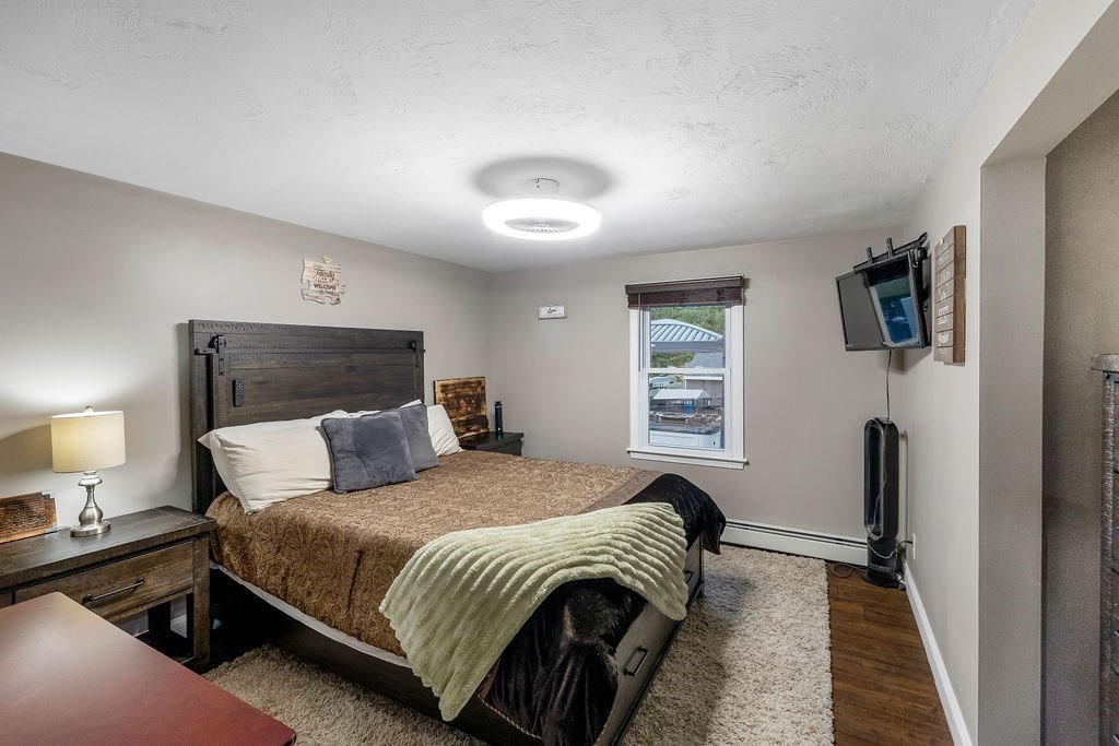 8 New Spencer Road Charlton, MA 01507 - Photo 12 of 42 a bedroom with a bed and a night stand