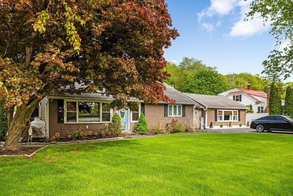 8 New Spencer Road Charlton, MA 01507 - Photo 2 of 42 a front view of a house with a garden