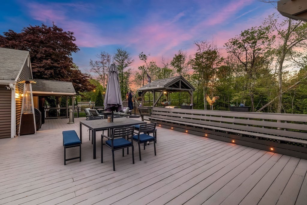 8 New Spencer Road Charlton, MA 01507 - Photo 27 of 42 a view of a patio with dining table and chairs with wooden floor and fence